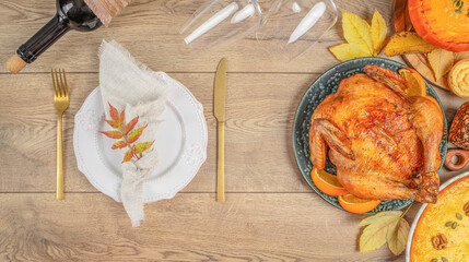 Elegant Thanksgiving dinner table setting with roasted turkey and autumn decorations. Long banner format. top view