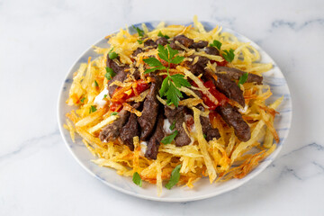 Turkish food; Cokertme Kebab - Beef meat kebab with yoghurt and french fries