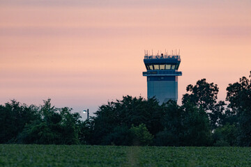Airport Control Tower at Sunset with Trees in Foreground