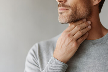 Fototapeta premium man gently places his hand on his neck showcasing moment of deep relaxation and tension relief