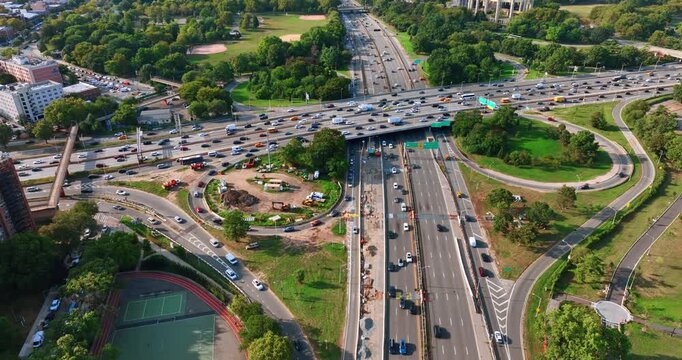 Highways, freeways and roundabouts with multiple moving cars. Rush hour in New York, USA. Aerial view.