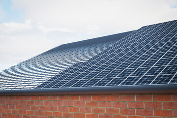 Shiny Blue Solar Panels on the roof of the house, solar energy.