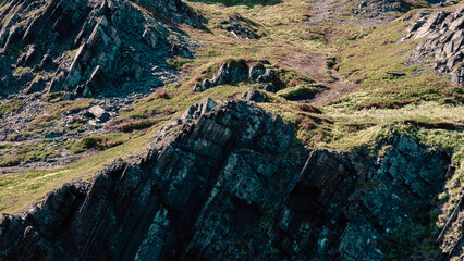mountains and rocks with fresh green grass on the shore of the Arctic Ocean without people