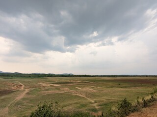A barren lakebed, cracked and silent under the sun’s gaze.