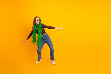 Young woman in colorful outfit posing joyfully against vibrant yellow background, conveying happiness and trendy fashion
