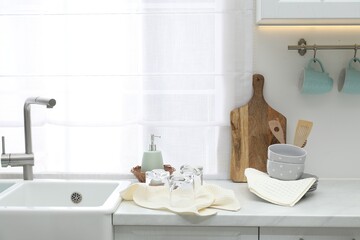 Clean dishware and waffle towels on countertop in kitchen