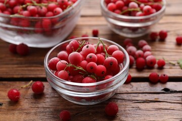 Ripe frozen red currants on wooden table, closeup