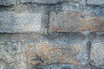 Close-up of 19th-century city street, showing the handmade brick pavers and mortar in use during the period.