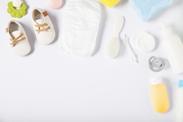 Baby accessories and cosmetic products on white background, flat lay. Space for text