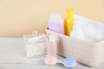 Different baby accessories on table against beige background
