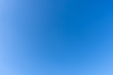 Low angle view and full frame of beautiful light blue sky without clouds in the afternoon on sunny day used as natural background texture in decorative art work