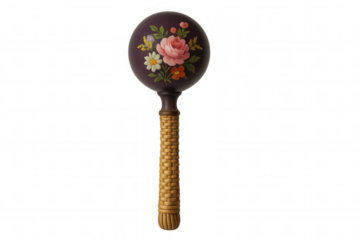 Studio shot of a purple maraca featuring a floral design and a woven handle, isolated on a transparent background