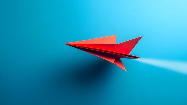 Vibrant Red Origami Paper Plane Blazing a Bold Trail Through the Sky