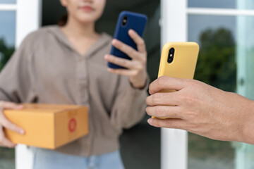Happy Asian woman scan QR code for pay goods delivery. Delivery man send deliver express. online shop, paper container, takeaway, postman, delivery service, packages, electronic money,
