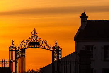 Belle ile morbihan Ornate Iron Gate Silhouette at Vibrant Sunset