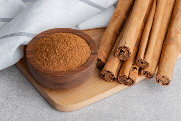 Ceylon cinnamon sticks and ground cinnamon powder on table aromatic spice with ayurvedic health benefits antioxidants and natural flavor.