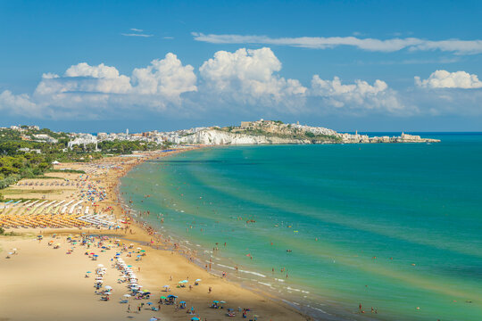 Tourists relaxing on the Pizzomunno Beach in Vieste, Italy