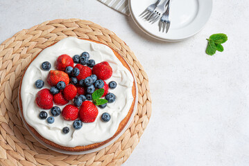 Sponge cake with whipped cream and fresh berries