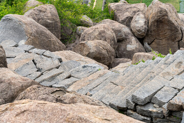 A rock wall with a staircase made of stone