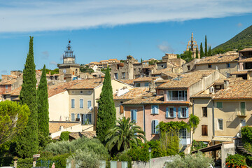 Fayence village skyline showing colorful houses and clock tower under blue sky