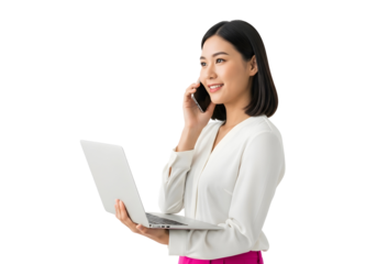 Smiling Asian woman adeptly multitasking with a laptop and mobile phone, embodying modern professional communication and digital connectivity.