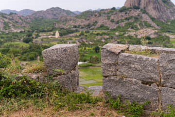 A large stone wall with a small opening in it