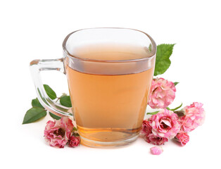 Tasty rose tea in glass cup and flowers isolated on white