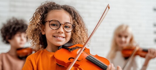 The cheerful girl playing the violin with friends in a bright classroom.