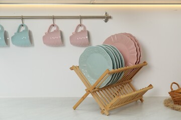 Drying rack with plates and cups in kitchen