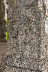 A stone pillar with a carving of a lion on it