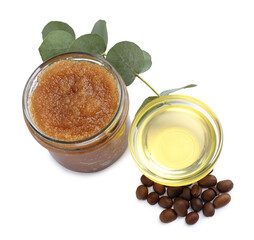 Natural body scrub in glass jar, coffee beans, oil and eucalyptus branch isolated on white, above view