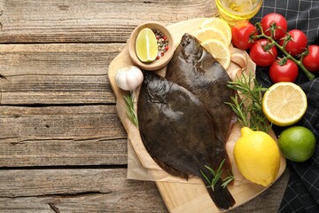 Fresh flounder fish, spices and products on wooden table, flat lay with space for text. Raw seafood
