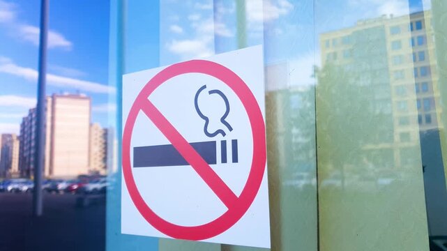 No smoking sign in a public place on glass. Symbol indicating that smoking is prohibited in this area.