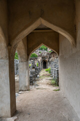 A narrow hallway with arched openings