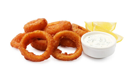 Fried squid rings, lemon and sauce isolated on white