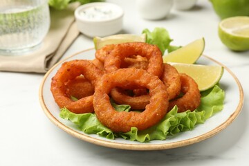 Fried squid rings served on white marble table, closeup
