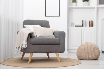 Comfortable grey armchair in living room. Interior design