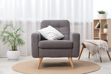 Comfortable grey armchair in living room. Interior design