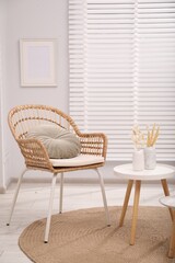 Comfortable armchair and side table in living room. Interior design