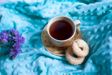 Cozy autumn composition with a large cup of coffee and cute decor details in the bed.