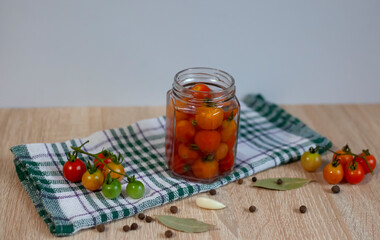 Canned tomatoes in glass jar on wooden rustic table in pantry or village kitchen, closeup, cottagecore, simple living aesthetics, home storage solution, saving leftovers, canning, fermentation concept