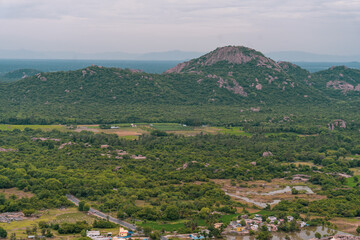 Fototapeta premium A mountain range with a green forest in the foreground
