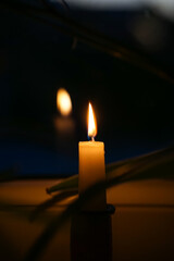 Candle light burning in the dark room ant late evening