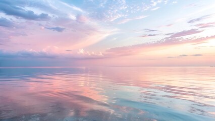 Fototapeta premium Pastel sunset reflecting on calm ocean water landscape background