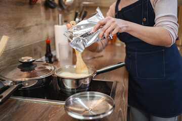 Cooking a delicious meal in a cozy kitchen during a sunny afternoon