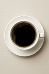 White cup filled with hot black coffee served on light background top view minimal style