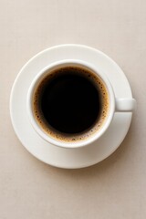 White cup filled with hot black coffee served on light background top view minimal style