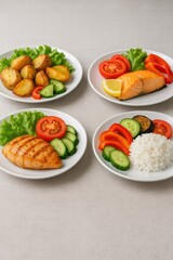 Assorted healthy meals with grilled chicken salmon potatoes rice and fresh vegetables served on white plates top view