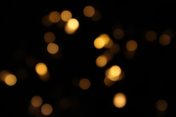 Christmas lights in bokeh. Outside in December. Red and fire orange bokeh on a black background, bokeh abstract background, modern technological abstract background. Orange Christmas background, Xmas  © TomKorcak