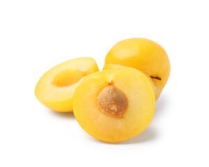 Whole and cut yellow cherry plums isolated on white